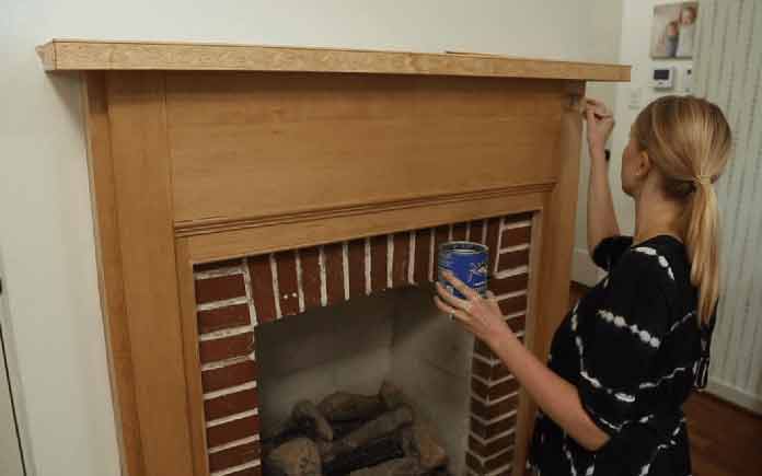 Chelsea painting her fireplace