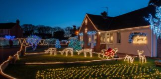 Christmas lights display on house lawn and roof
