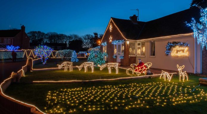 Christmas lights display on house lawn and roof