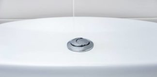 Toilet with dual-flush button on the tank cover