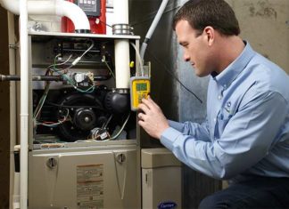 HVAC professional checking air conditioner