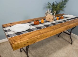 Thanksgiving buffet on plastic table topped with a homemade wood covering.