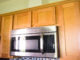 Over the range microwave went vent pipe concealed with cabinet-grade plywood.