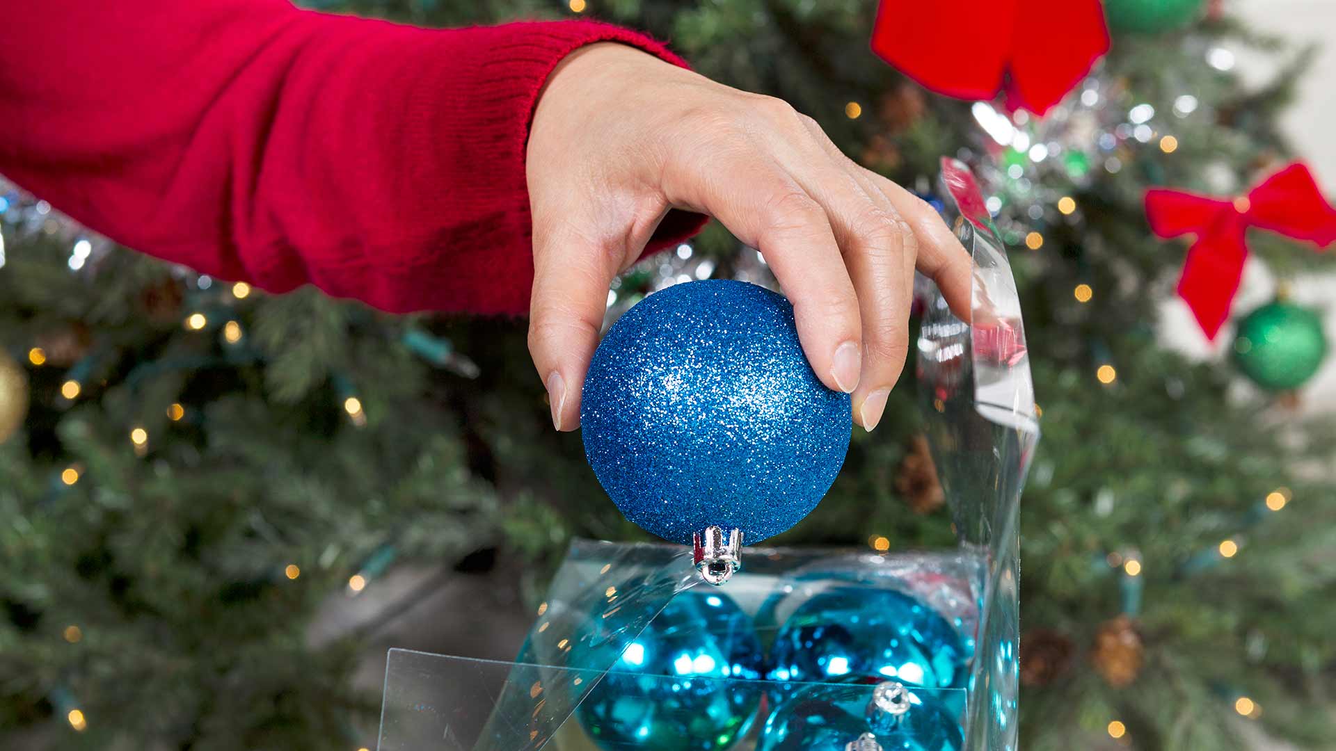 Storing Christmas ornaments in a clear plastic box