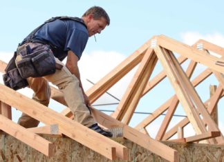 Home builder installing timber roof trusses