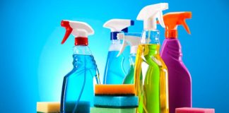 Assorted house cleaning products, spray bottles and sponges