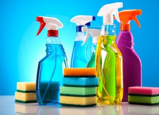 Assorted house cleaning products, spray bottles and sponges