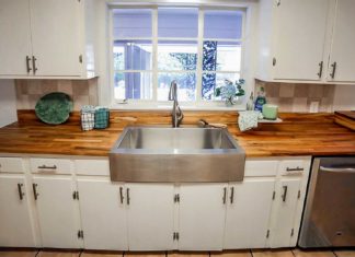 Kitchen design featuring a butcher block countertop and stainless steel apron sink
