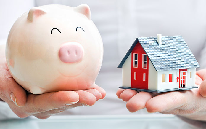 Piggy bank and house symbolizing real estate