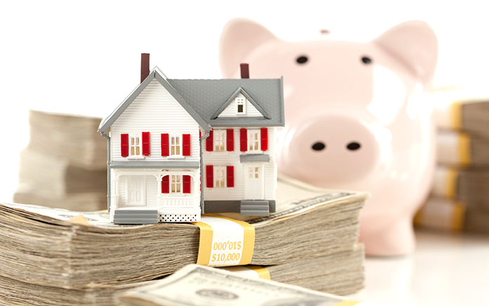 Piggy bank and stacks of cash for down payment