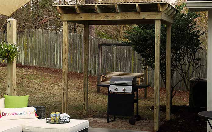 Grill shelter, as seen in backyard with privacy fence