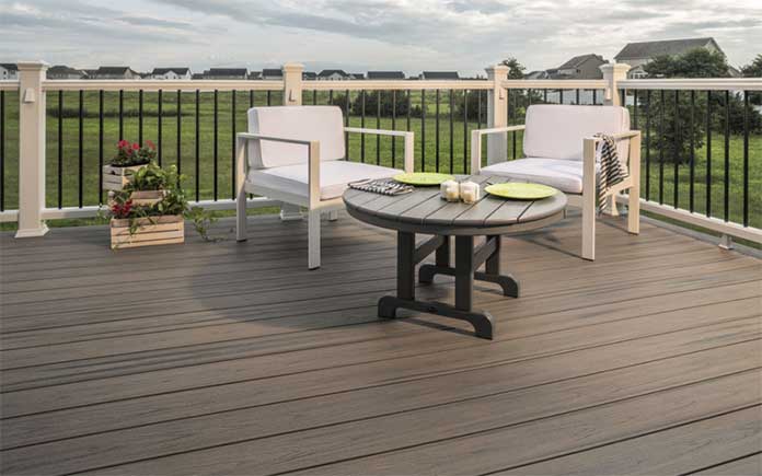 Trex decking, Rocky Harbor style, shown at eye level along with two chairs and a table