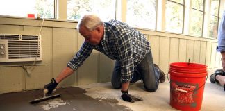 Danny Lipford spreading concrete mix inside a house