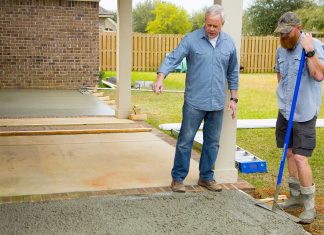 Danny Lipford looks at a wet concrete patio in production at the job site