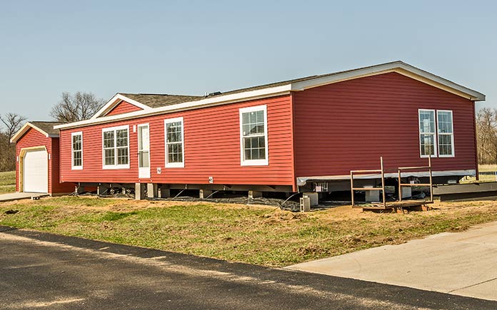 Red modular home just installed on land in the country