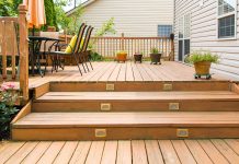 Deck stairs leading up to a townhouse with vinyl siding