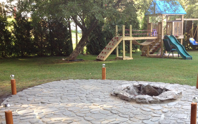 Concrete fire pit surrounded by patio made from Quikrete WalkMaker