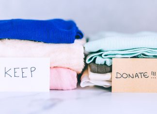 Two piles of old clothes beside each other. In front of one pile is a sign that says, 'keep.' In front of the other pile is a sign that says, 'Donate.'