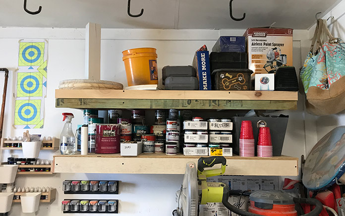 Paint cans stored on wood shelving in Sabrina and Bill Gordon's garage
