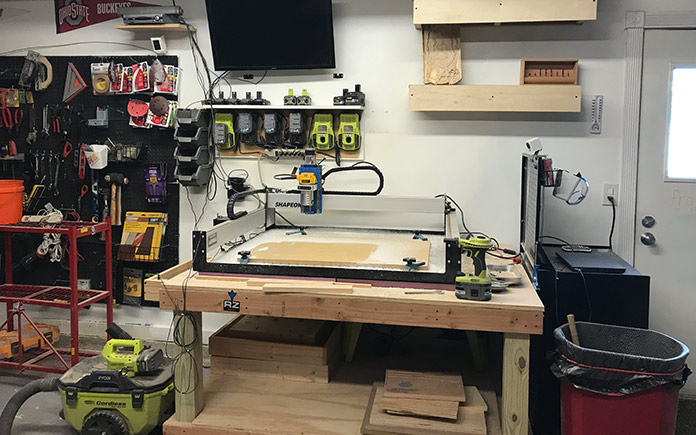 Sabrina and Bill Gordon's CNC router, sitting on a wood table in their garage