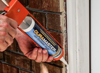 Caulking a gap in the doorway outside a home with Titebond DuraMaster sealant