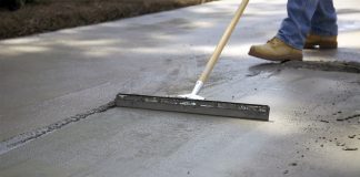 Man applies Quikrete Re-Cap Resurfacer to spalling concrete slab