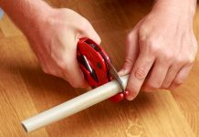 Man cuts pvc pipes with red pvc cutters