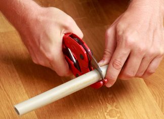 Man cuts pvc pipes with red pvc cutters