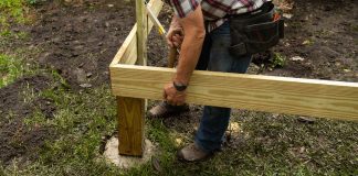 Danny Lipford installs wood deck post in concrete footing