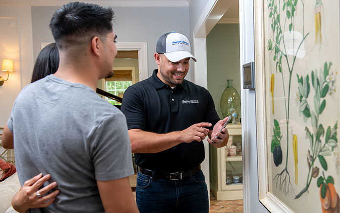 American Standard Heating and Air Conditioning technician installs a smart thermostat