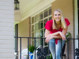 Chelsea Lipford Wolf, host of Today's Homeowner, stands beside wrought iron railing on her front porch.