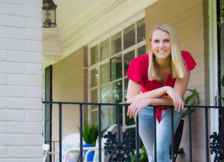Chelsea Lipford Wolf, host of Today's Homeowner, stands beside wrought iron railing on her front porch.