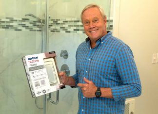 Danny Lipford, posed in this home bathroom, points to a box with a Broan-NuTone ventilation fan that he will install in his personal shower.