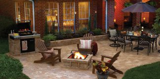 Hardscape features in a luxurious backyard, featuring a paver patio, Adirondack chairs, and an outdoor dining set