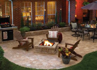 Hardscape features in a luxurious backyard, featuring a paver patio, Adirondack chairs, and an outdoor dining set