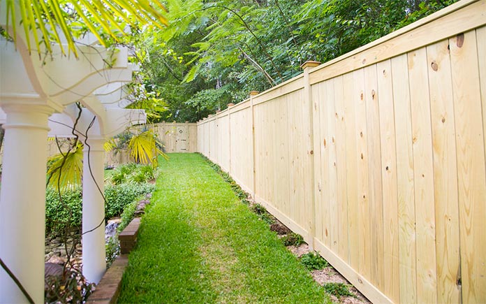 Newly installed wooden fence in a luxurious backyard