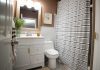 Beautiful modern bathroom with painted walls and new toilet and porcelain tile floors