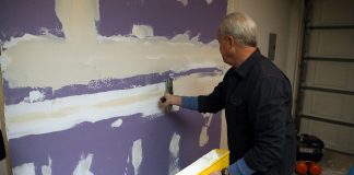 Danny Lipford, host of Today's Homeowner, installs Purple XP drywall on some garage walls.
