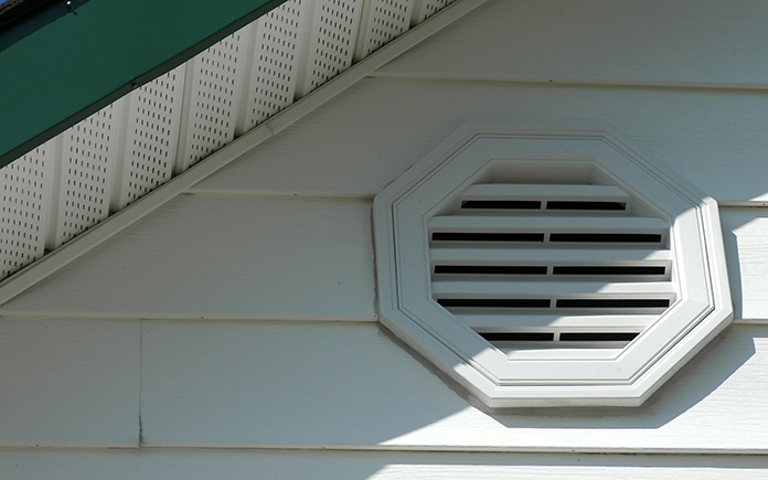 Closeup of a home with a gable vent and soffit vents