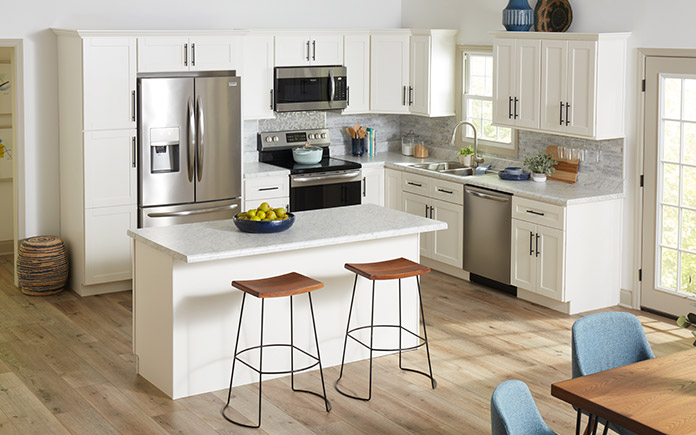 Beautiful white shaker cabinets in a modern kitchen with stainless steel appliances. 