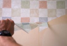 Removing checkered wallpaper from a wall.