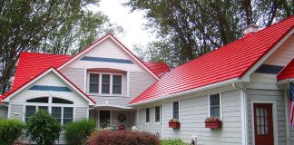 Red metal roof on a white wood house