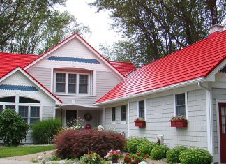 Red metal roof on a white wood house