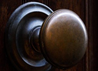brass doorknob on wooden door