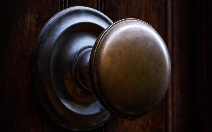 Brass doorknob on wooden door