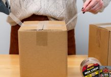 Woman uses Scotch moving tape while packing boxes during move-out