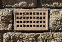 Crawl space vent, as seen on a brick home