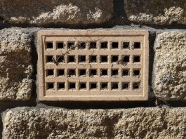 Crawl space vent, as seen on a brick home