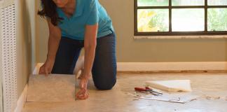 Woman installs peel-and-stick vinyl tile in her living room