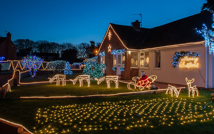 A home lit up with Christmas decorations and lights